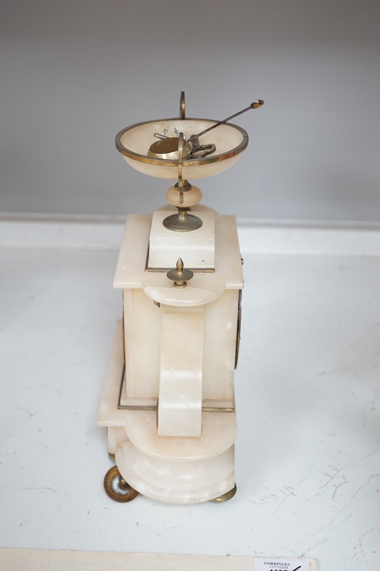 A Victorian alabaster mantel clock, striking on a bell, height 27cm. Condition - fair.